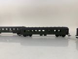 a black train car sitting on a white surface