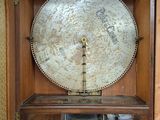 a clock that is in a wooden case on a table