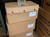 a glass sitting on top of a stack of boxes