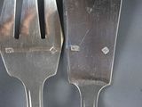 two forks that are sitting next to each other on a table