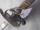 a close up of a sword with a tag on it