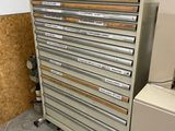 a metal cabinet with many drawers on it in a room