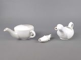 two teapots and a tea cup on a table