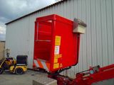 a red box sitting on the back of a forklift