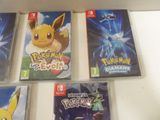 several nintendo wii games are on display on a white surface