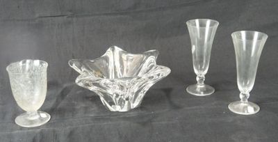 trois vases en verre transparent et un petit vase sur fond noir