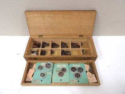 a wooden box that has a bunch of coins inside of it