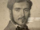 portrait of a man in a suit and bow tie with a mustache