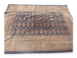 a close up of a blue and brown rug on a white surface
