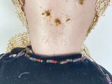 a close up of a doll ' s head with dirt all over it
