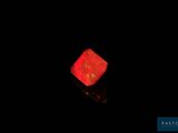 a red glowing dice sitting on top of a black surface