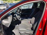 a red car with the door open in a parking lot