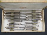a bunch of silverware in a box on a table