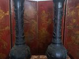 two vases that are sitting on a table