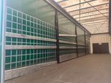 the inside of a storage building with green glass walls