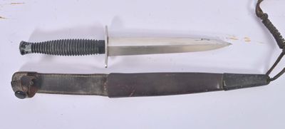 a knife that is laying on a table next to a knife