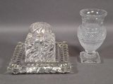 two glass vases sitting next to each other on a table