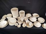 a lot of white and brown plates and bowls on a table