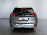 the rear end of a silver suv parked in a room