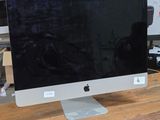 a computer monitor sitting on top of a wooden table