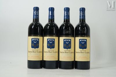 quatre bouteilles de vin sont alignées sur une table