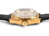 a watch that is sitting on a black leather strap