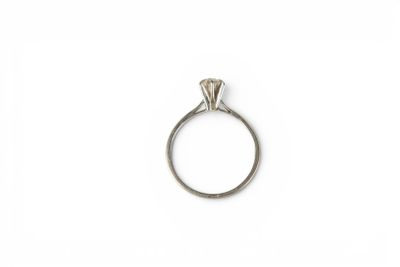 a close up of a diamond ring on a white surface
