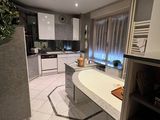 a kitchen with a stove, sink, oven, and refrigerator in it