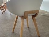 a white chair with wooden legs and a white chair with a white seat