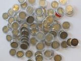 a pile of coins sitting on top of a white table