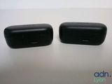 two black speakers sitting on top of a table next to each other