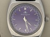 a close up of a wrist watch with a purple dial
