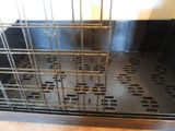 a metal cage with holes in it on the floor