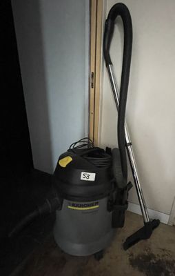 a vacuum cleaner that is sitting next to a door