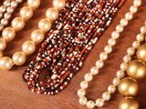 many different types of pearls and beads on a table