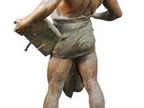 statue of a man holding a surfboard on top of a stone base