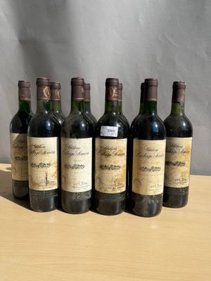 six bottles of wine sitting on top of a wooden table