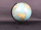 an image of a blue and green globe on a black stand