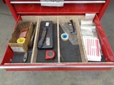 a red tool box with tools in it on the floor