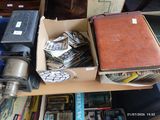 a box full of books and a suitcase sitting on a table