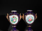 pair of purple and gold vases with flowers on them against a black background
