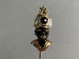 a gold stick with a black and white hat on it