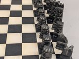 a black and white chess board with chess pieces on it