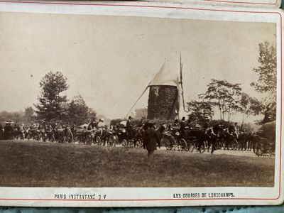 an old photo of a group of people riding horses