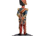 a figurine of a soldier with a sword on a wooden base