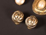 several pieces of jewelry are displayed on a black surface
