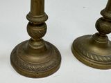 pair of antique brass candlesticks on a white background