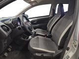 the interior of a small car with a steering wheel and a dashboard