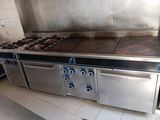 a large stainless steel stove in the middle of a kitchen