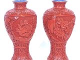 two vases that are sitting on a white surface